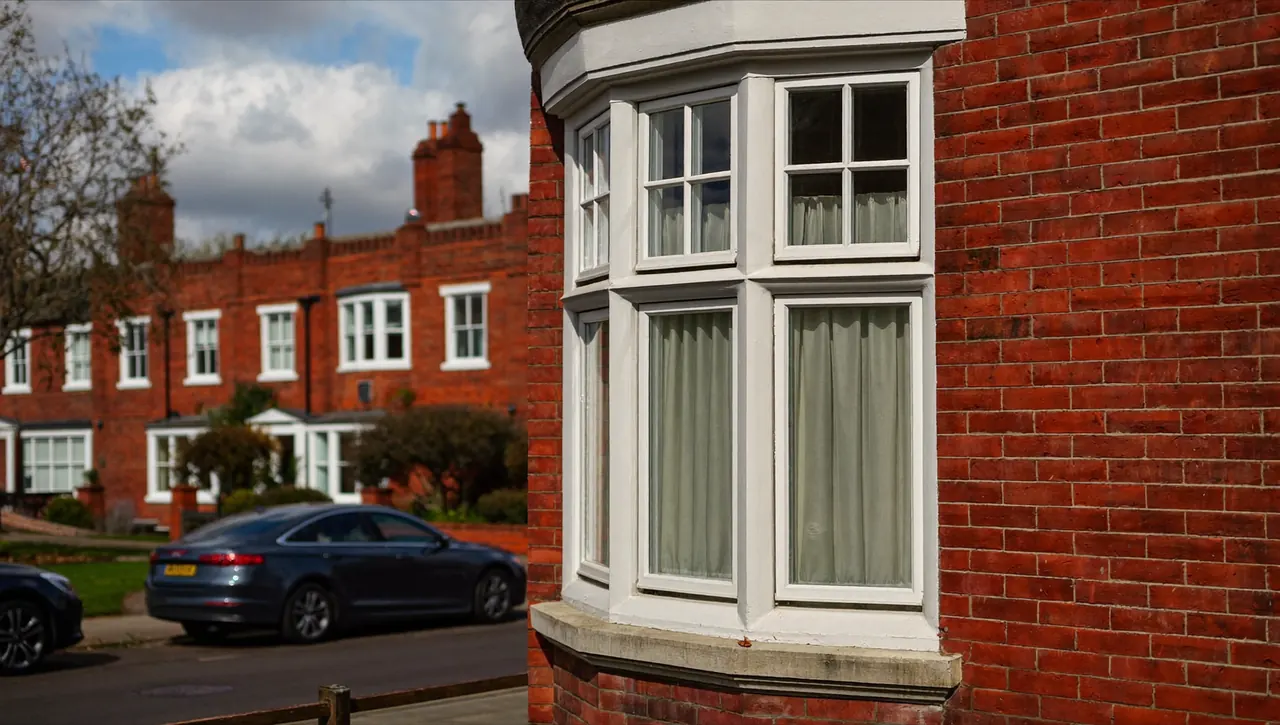 uPVC casement windows on a red-brick terraced house